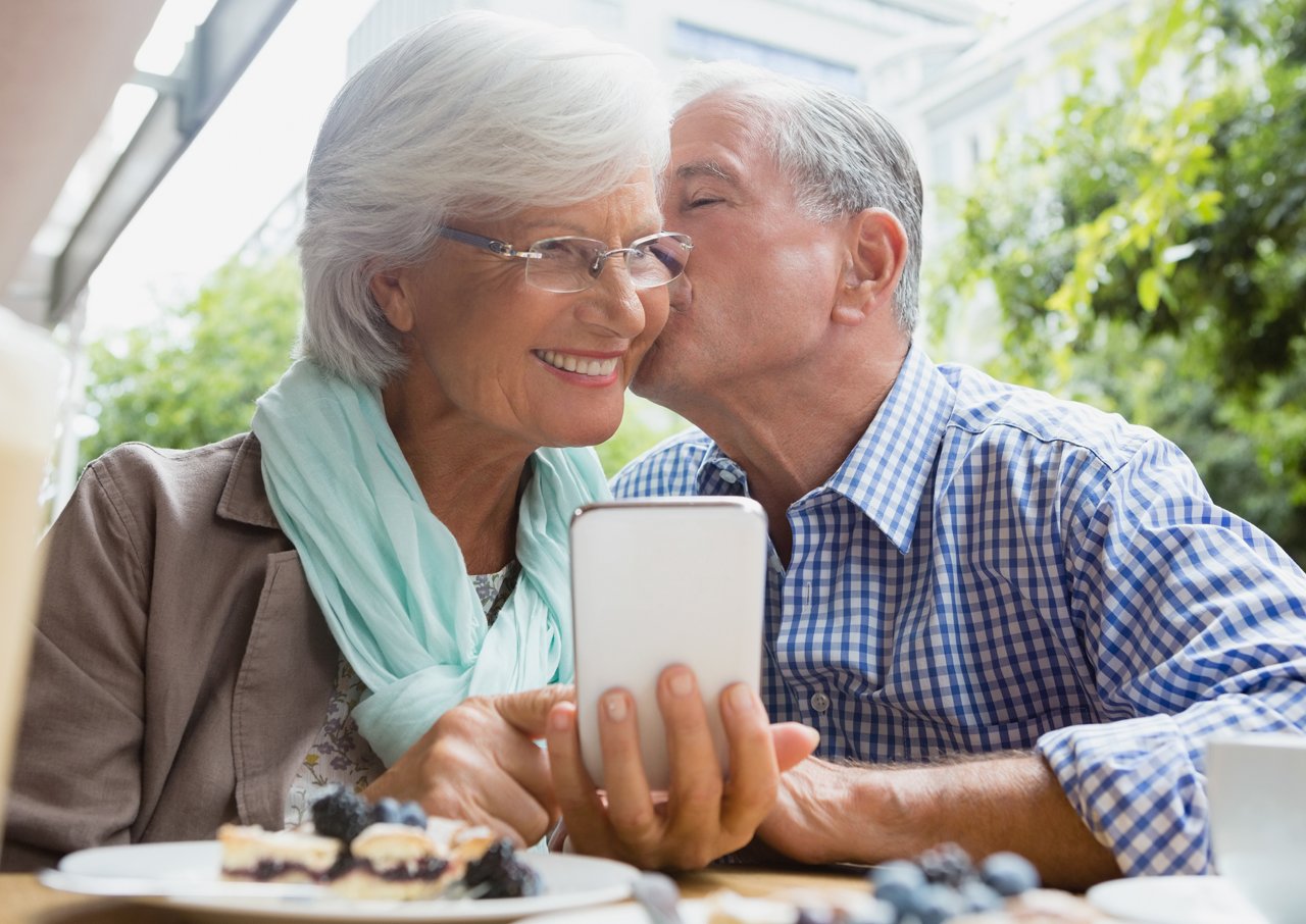 Mature couple in hotel with smartphone