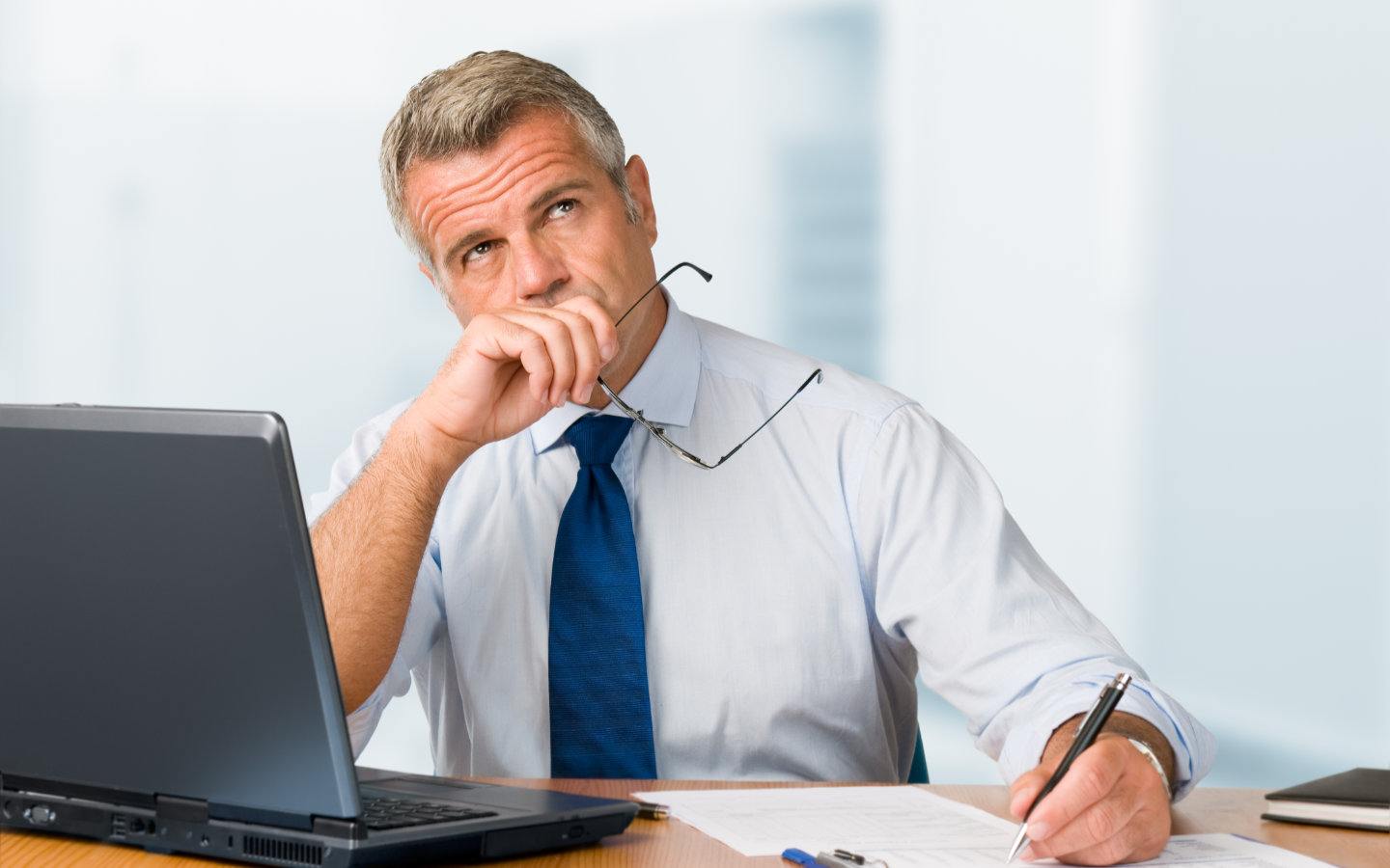 Thoughtful hotelier sitting at his desk